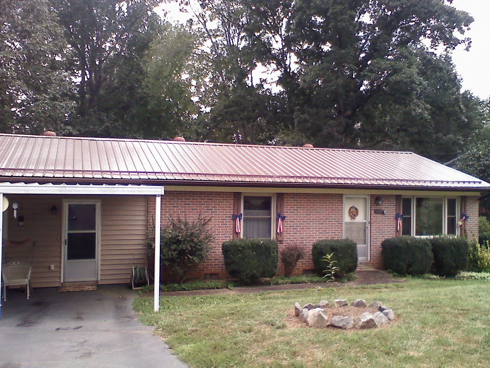 Bronze metal roof and carport on a brick ranch home — Roof Repair work by our crew in Wrightsville
