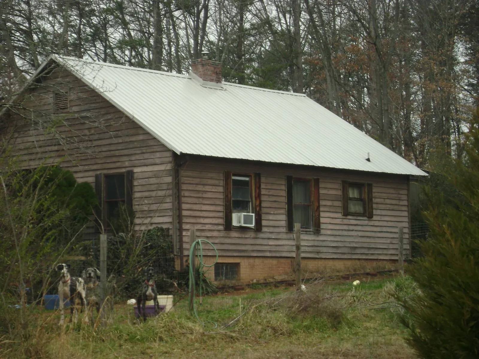 White metal roof on an old wood sided farmhouse in Wrightsville
